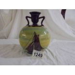 An attractive round bulbous vase or candle holder with two shoulders. Brown with paintings of yachts