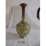 A Doulton Slaters patent 11" high bulbous vase with long neck in greens, deep red, white and gold.