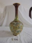A Doulton Slaters patent 11" high bulbous vase with long neck in greens, deep red, white and gold.