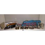 A box of miscellaneous including The friction train, Bachmann train, Morris Minor badge & other