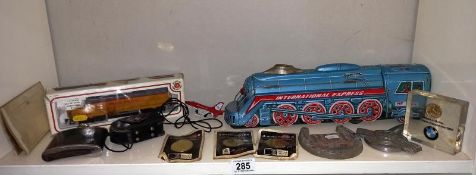 A box of miscellaneous including The friction train, Bachmann train, Morris Minor badge & other
