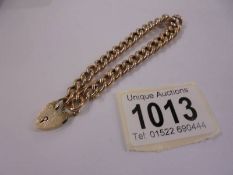 A 9ct gold bracelet with padlock and safety chain, 10 grams.