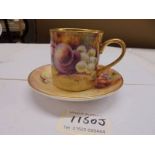 A hand decorated coffee cup and saucer signed Bryan Cox, (Ex Royal Worcester).