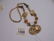 A vintage bone necklace with elephant carvings.