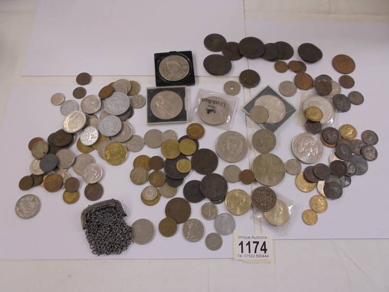 A mixed lot of UK and foreign coins including crowns, £5 etc.,