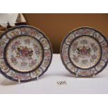 A pair of early Chinese hard paste porcelain plates with centre crests.