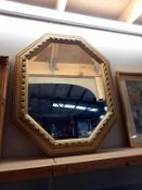 A large gilt frames octagonal bevel edge mirror, 66cm x 82cm (COLLECT ONLY)