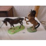 A Beswick rearing horse and one other.