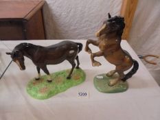 A Beswick rearing horse and one other.