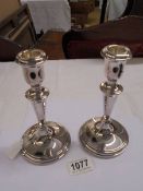 A pair of silver candlesticks, 18cm tall.