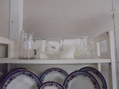 Three cut glass jugs.