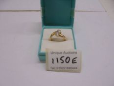 An 18ct gold ring set two white stones, size R half. 3.6 grams.