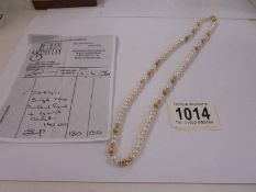 A single row cultured pearl and gold necklace with original purchase receipt for 1994.