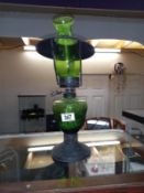 A vintage green glass & black steel oil lamp