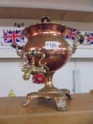 A Victorian copper samovar with brass tap.