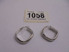 A pair of 9ct white gold ear hoops.