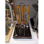 A set of kitchen knives with chopping board and an 18 piece cutlery set
