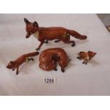 Four Beswick foxes.