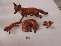 Four Beswick foxes.