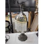 A desk lamp with Tiffany style beaded shade.