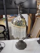 A desk lamp with Tiffany style beaded shade.