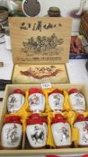 A cased set of 8 porcelain jars with liquid contents from Taiwan Tobbaco & Wine Monopoly Bureau,