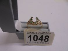 An unusual emerald set horse shoe ring dated London 1978 set with 7 emeralds