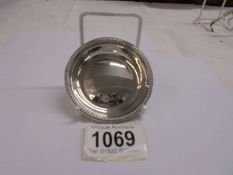 A small silver coaster, 7cm diameter, 38 grams.