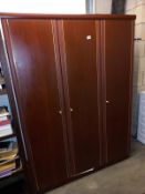 A Darkwood stained triple wardrobe with Brusso'd detailing