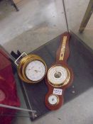 A brass ship's barometer and another barometer.