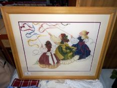 A pine framed tapestry of 3 girls