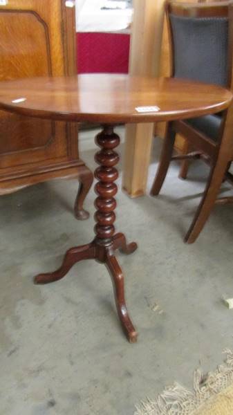 An oval oak occasional table on tripod base with bobbin turned column. COLLECT ONLY.