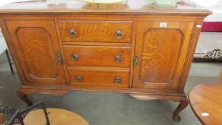 A good quality oak sideboard with two cupboards and three central drawers, COLLECT ONLY.