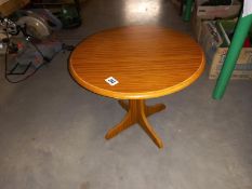 A small round teak effect coffee table diameter 48cm, height 41cm