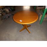 A small round teak effect coffee table diameter 48cm, height 41cm