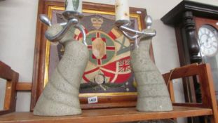 A pair of contemporary figural candle holders.
