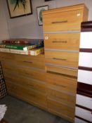 A lightwood effect 8 drawer bedroom chest of drawers and 2 x 3 bedsides