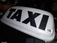 A 'Taxi' illuminated roof sign