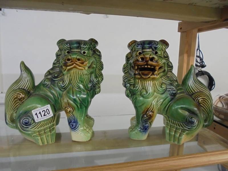 A pair of green ceramic Chinese Dogs of Fo.