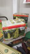 Four boxed Hornby buildings.
