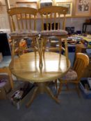 A round to oval extending dining table and 4 chairs