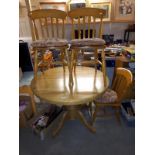 A round to oval extending dining table and 4 chairs