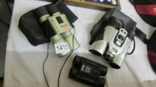Three pairs of binoculars - Vivitar, Prisma and Horizon.