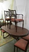 An oval mahogany dining table with six chairs. COLLECT ONLY.