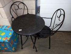 A wrought iron patio garden table and 2 chairs