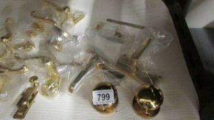 A quantity of brass door handles.