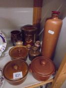 A mixed lot of stoneware bottles, lidded dishes etc.,