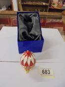 A boxed enamel and gilt egg pill box.