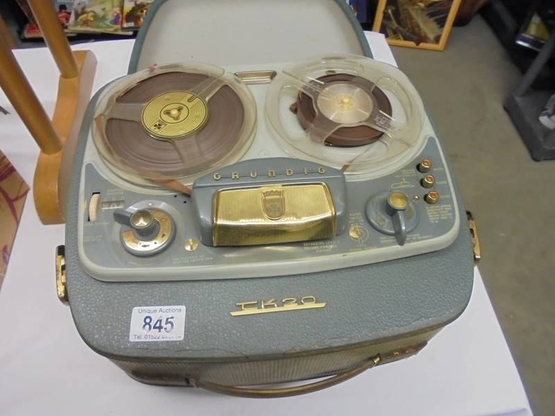 A vintage reel to reel tape recorder.