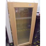 A light wood display cabinet. COLLECT ONLY.